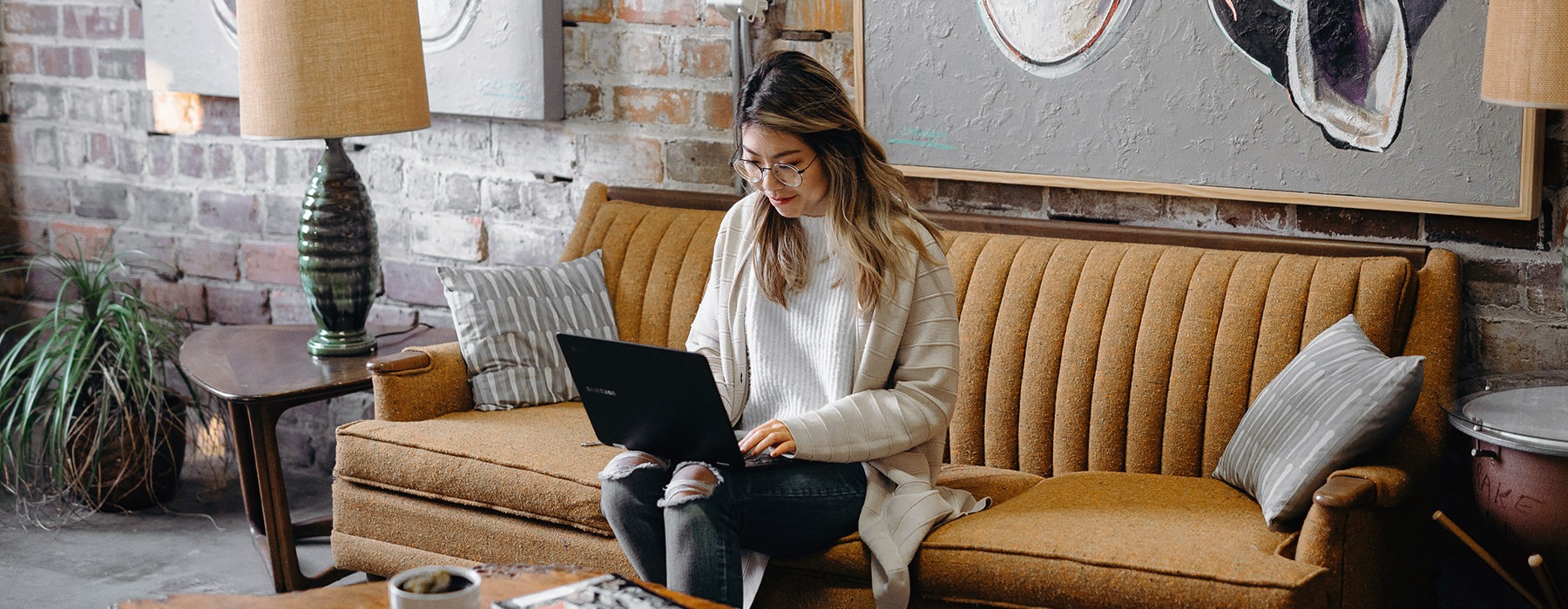 woman on couch with laptop